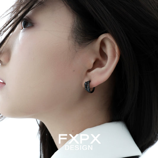 Elegant blue black rose stud earrings worn by a model with long hair for a chic look