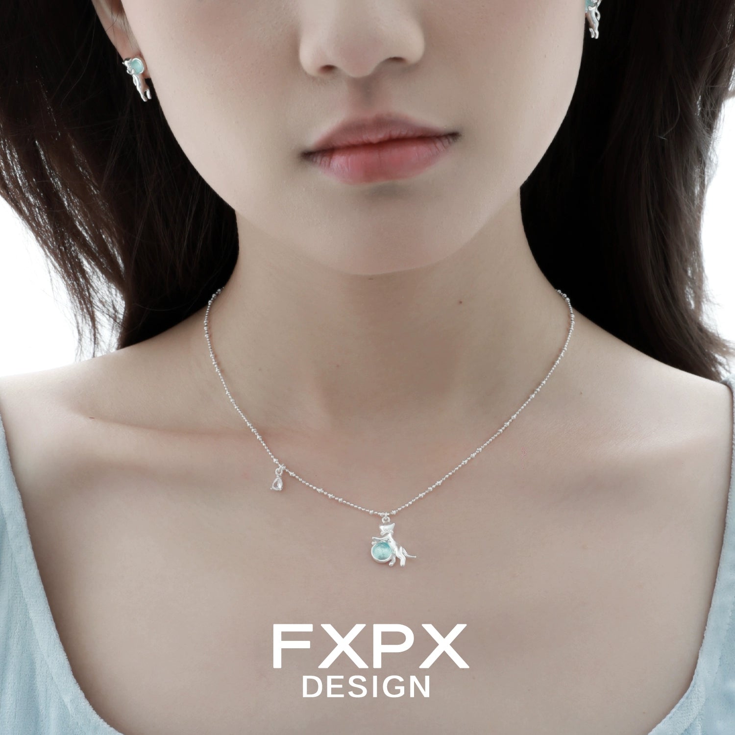 Beautiful blue cat pendant necklace by FXPX with matching earrings for a stylish look