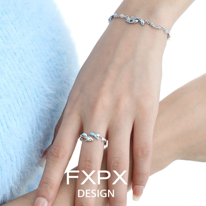 FXPX blue fish wave ring elegantly worn on a hand, showcasing its unique design and shimmering detail