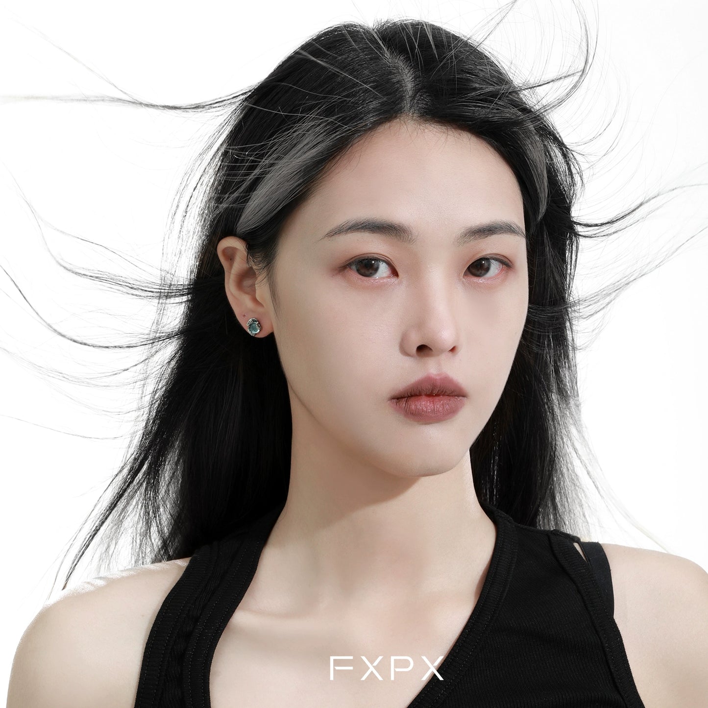 Model wearing blue snake stud earrings showcasing unique design and elegant style