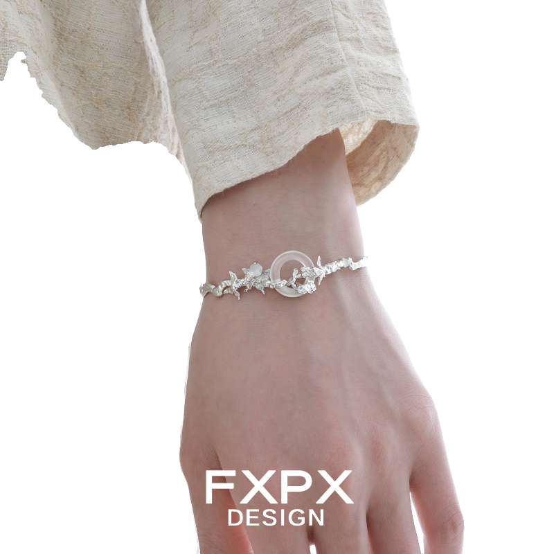 FXPX butterfly sigil bracelet in silver with intricate floral detailing worn on a wrist