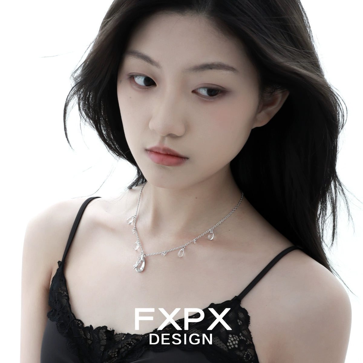 Butterfly water drop silver necklace elegantly worn by a model with a simple black top
