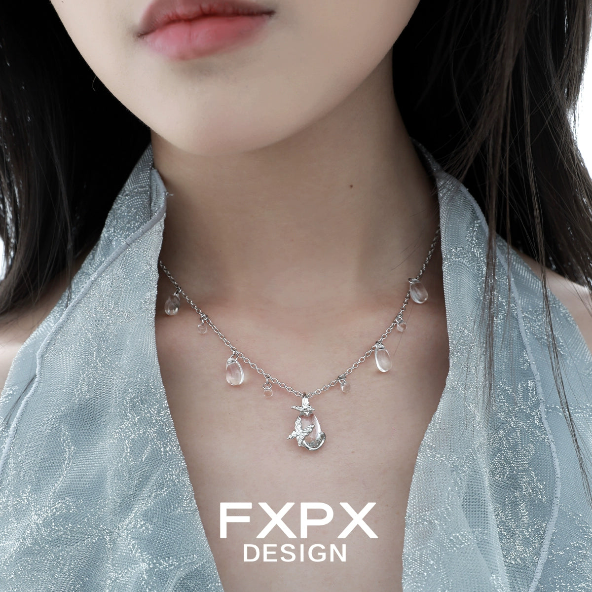 Stylish butterfly water drop silver necklace featuring delicate charms and a shimmering design