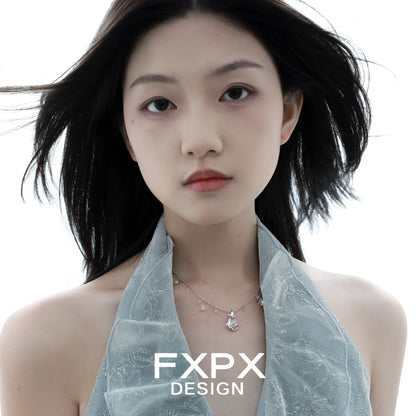 Elegant butterfly water drop silver necklace displayed on a model wearing a soft blue halter top