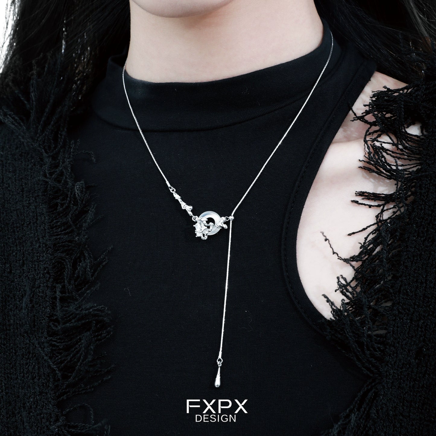 Elegant celestial eclipse agate necklace displayed on a model's neck, featuring a unique design and silver accents