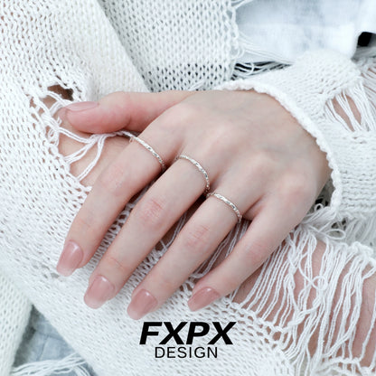 FXPX minimalist textured thin ring displayed on a model's hand with delicate detailing