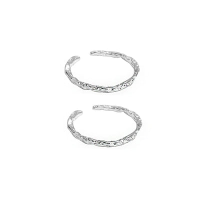 Two FXPX minimalist textured thin rings with a unique design in a silver finish