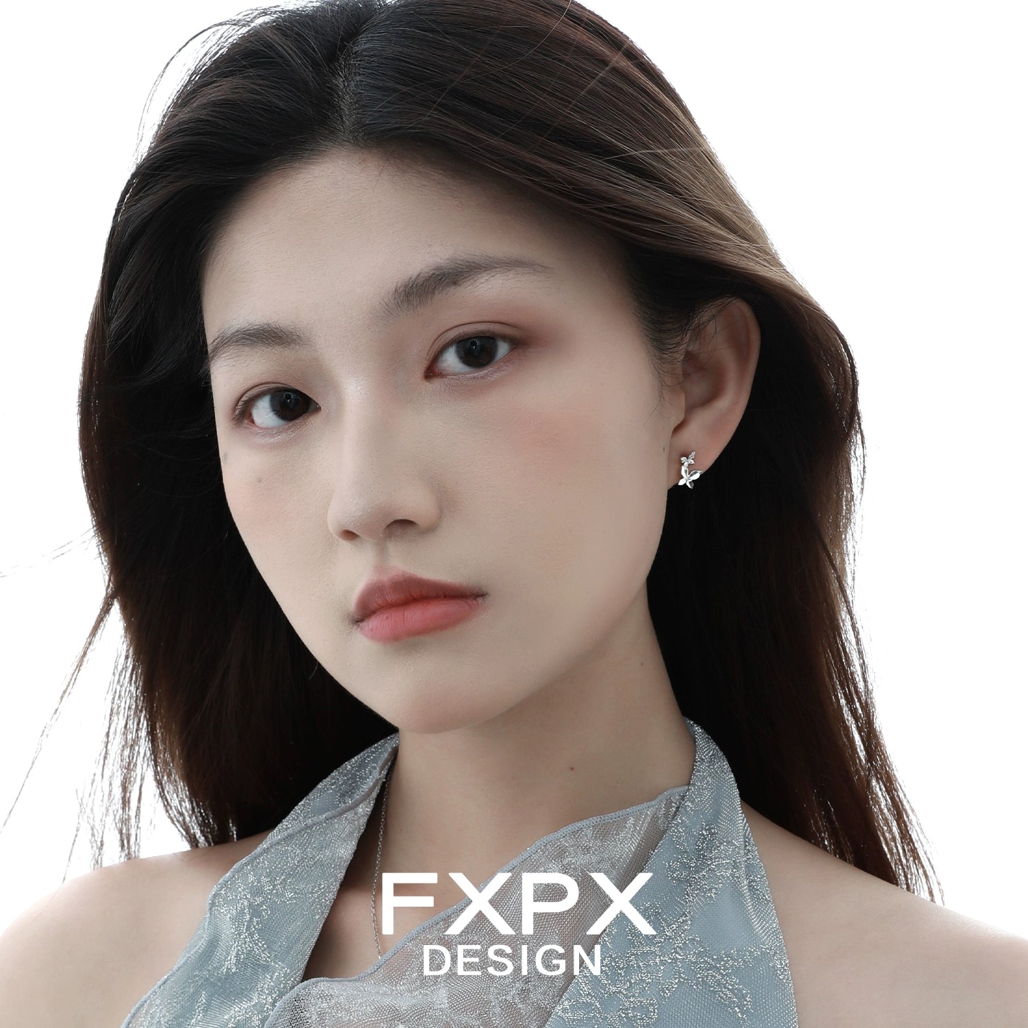 Elegant mirror butterfly silver earrings showcased on a model with long hair and natural makeup