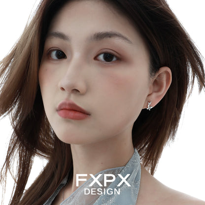 Mirror butterfly silver earrings by FXPX displayed on a model with flowing hair