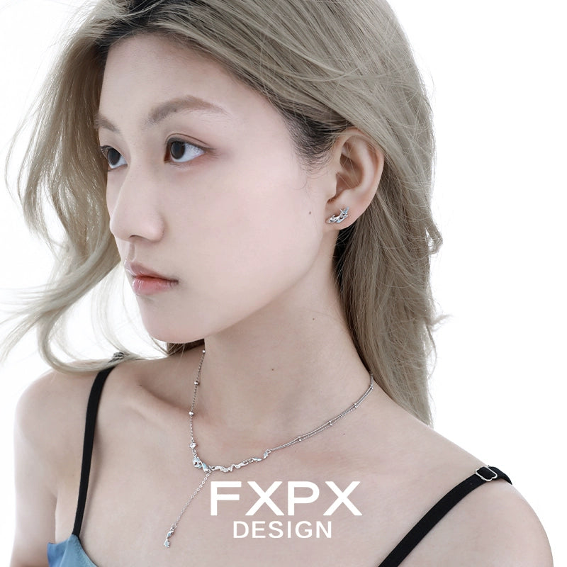 Stylish FXPX mystic mermaid earrings featured on model with long hair and chic attire