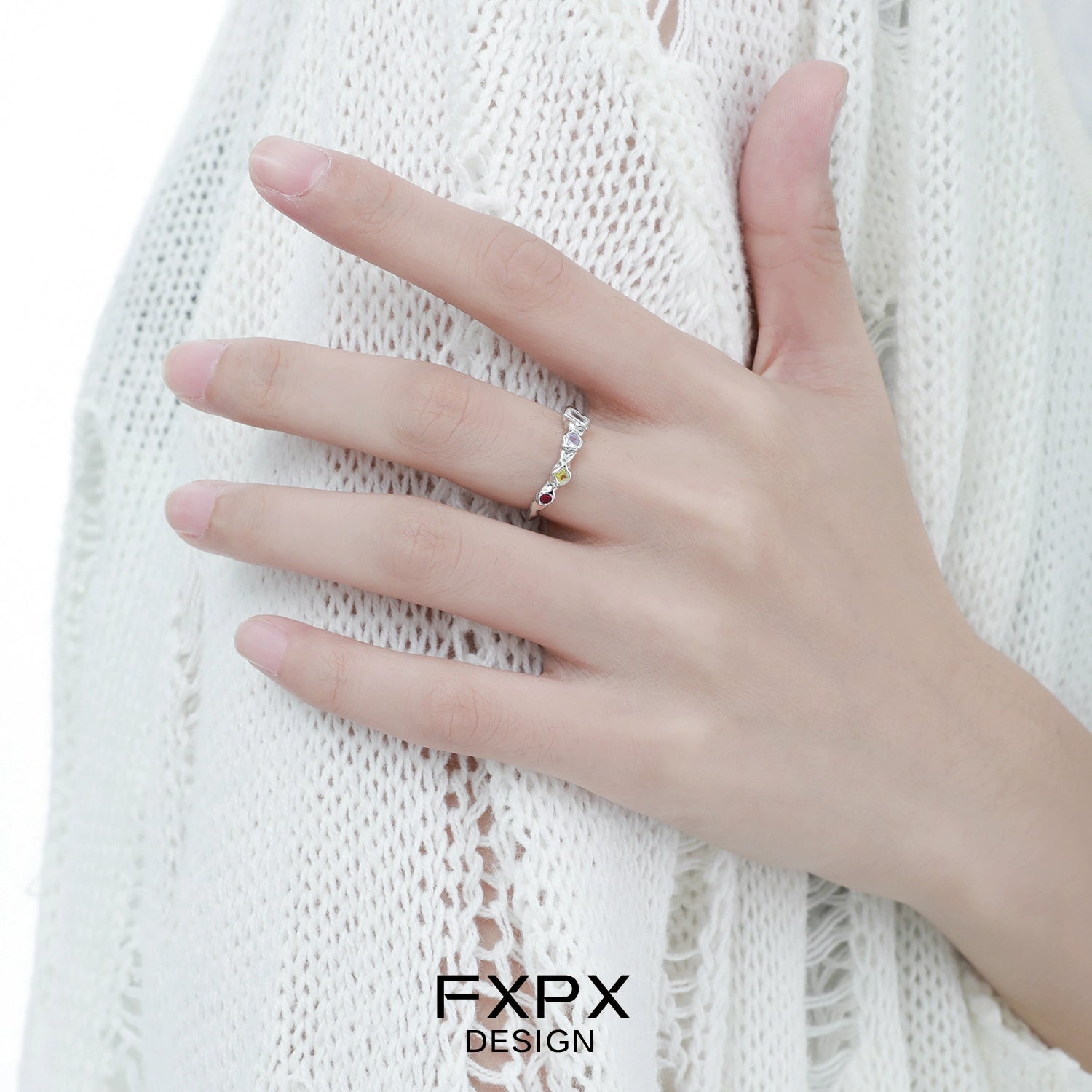 Dopamine colored zircon ring showcased on a model's hand with a stylish outfit