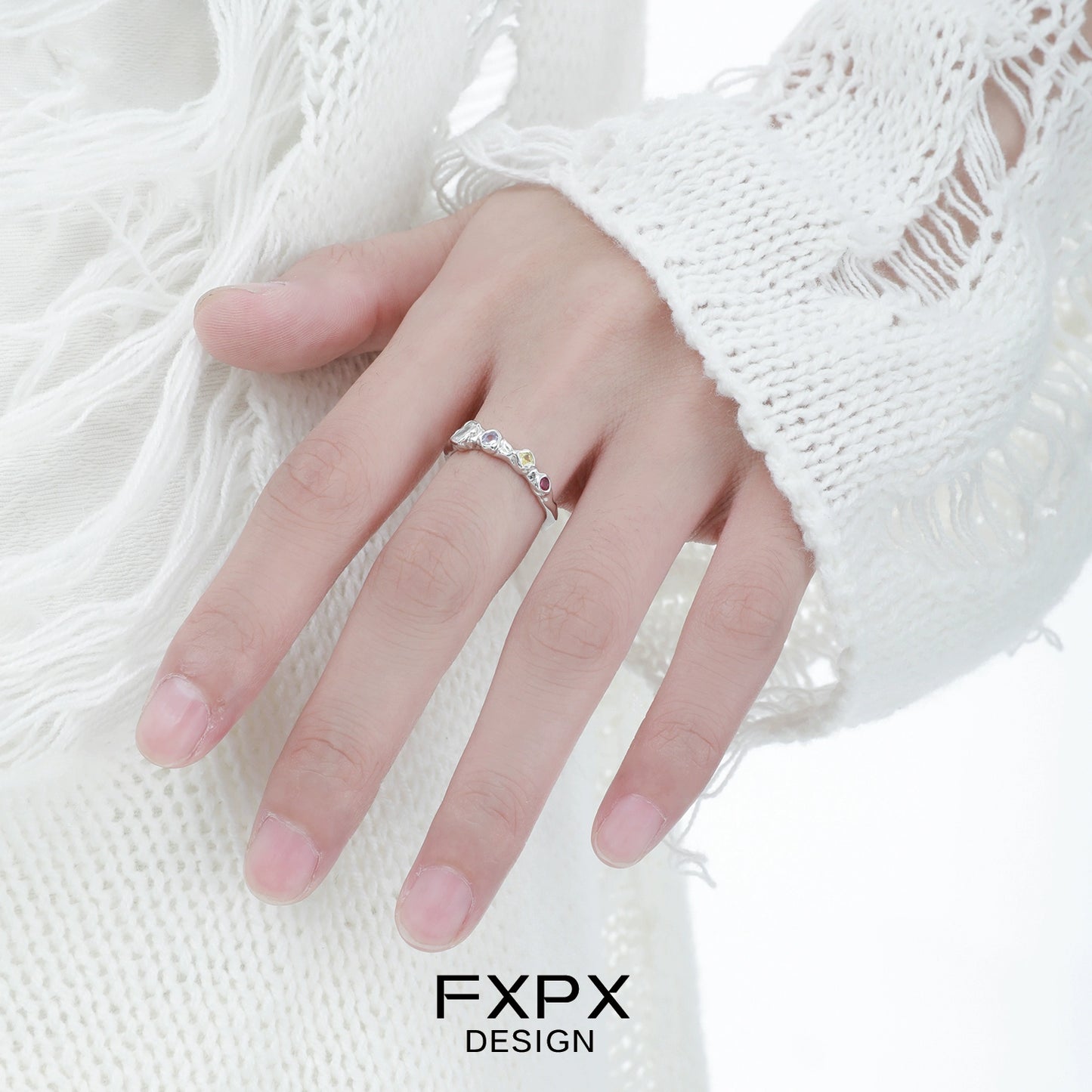 Elegant FXPX dopamine colored zircon ring showcased on a hand with a stylish white sweater