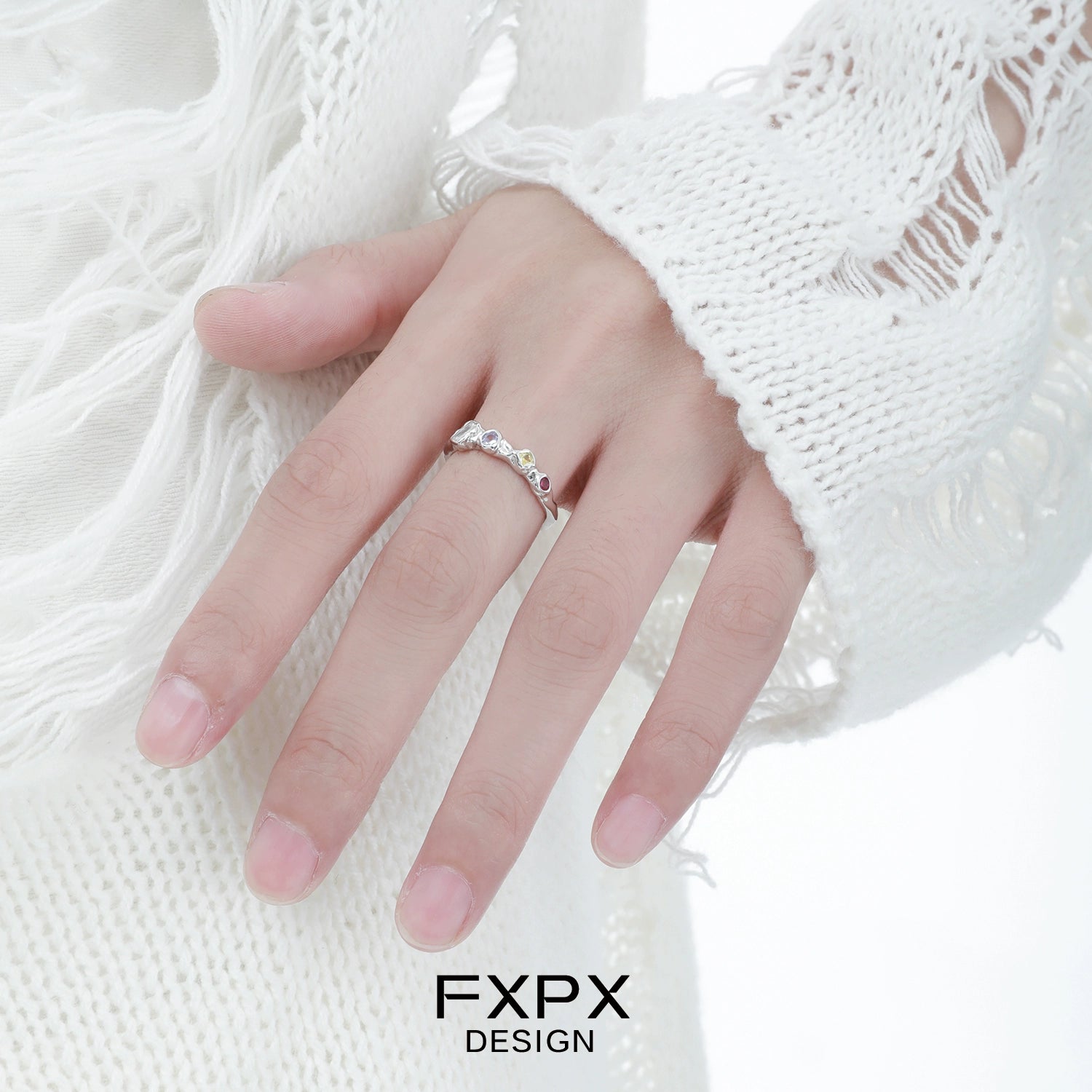 Elegant FXPX dopamine colored zircon ring showcased on a hand with a stylish white sweater