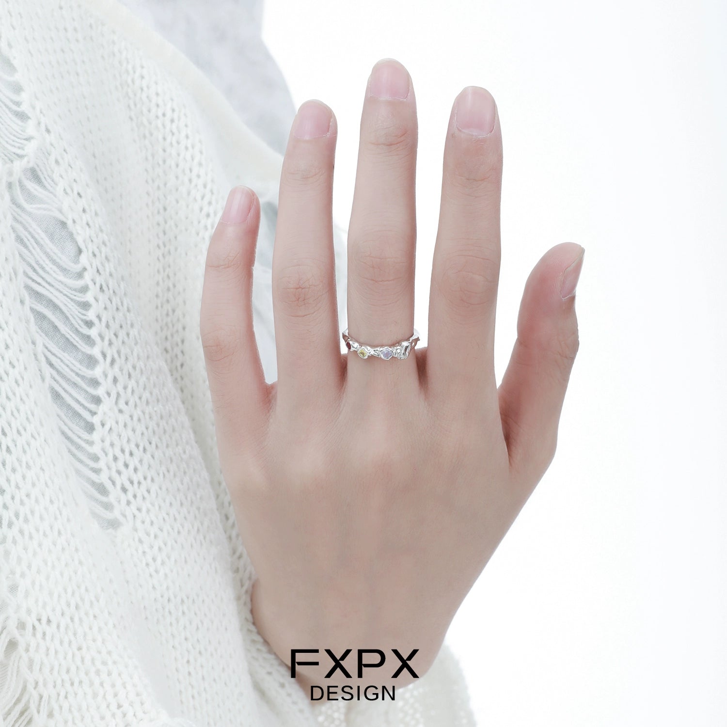 Elegant FXPX dopamine colored zircon ring showcased on a hand with a delicate design