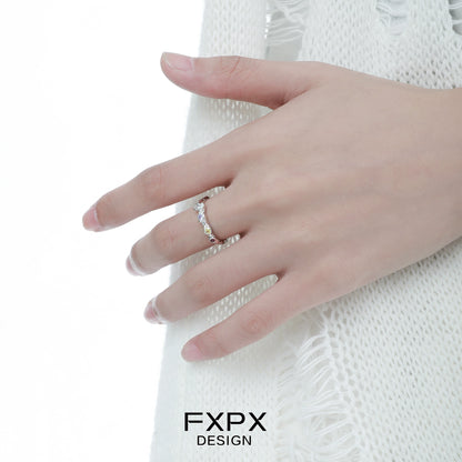 Elegantly displayed dopamine colored zircon ring on a hand, showcasing vibrant gemstones for a stylish look