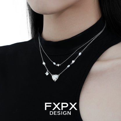 Double layer silver love necklace featuring delicate heart and bead accents on a model's neck