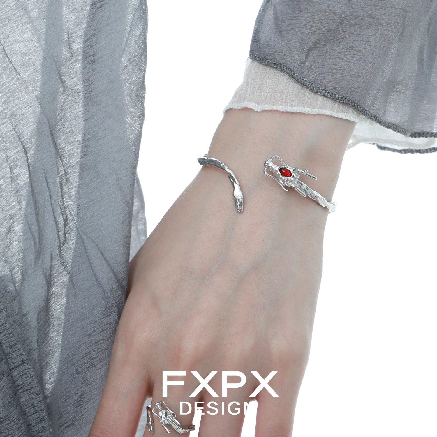FXPX dragon guardian silver bracelet featuring intricate design and red gemstone accent