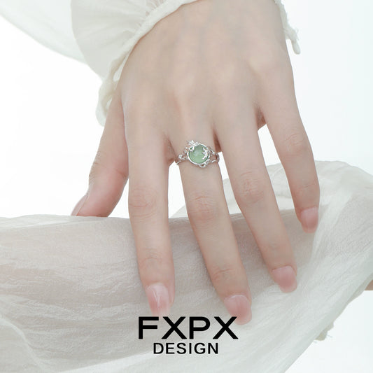 Elegant FXPX eagle claw gemstone ring featuring a stunning green stone on a delicate band