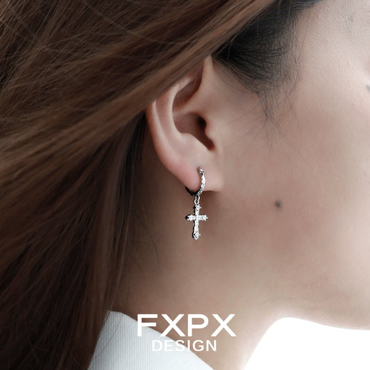 Frosted cross zircon earrings dangling elegantly from a woman's ear, showcasing intricate details