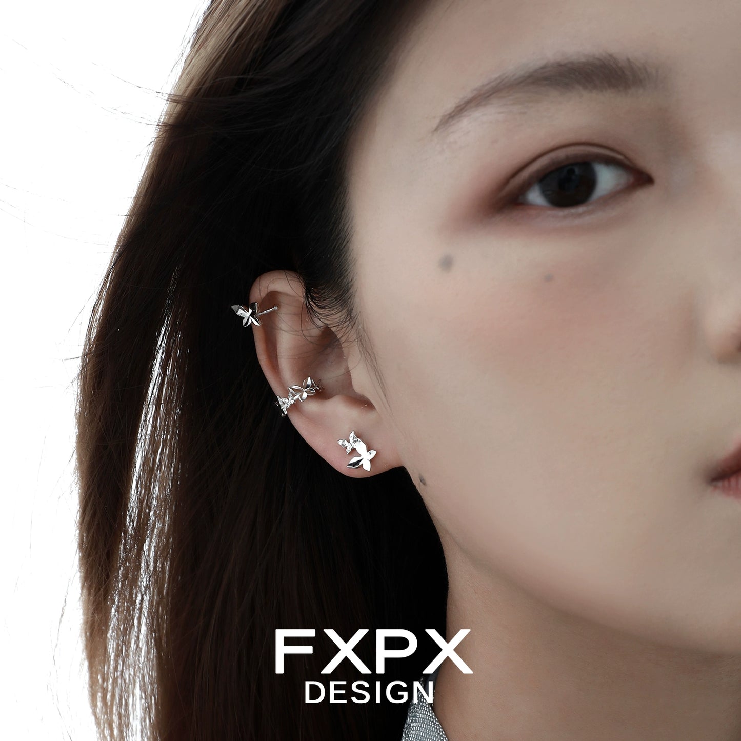 Stylish FXPX futuristic butterfly ear cuff design worn on a model's ear for a trendy look