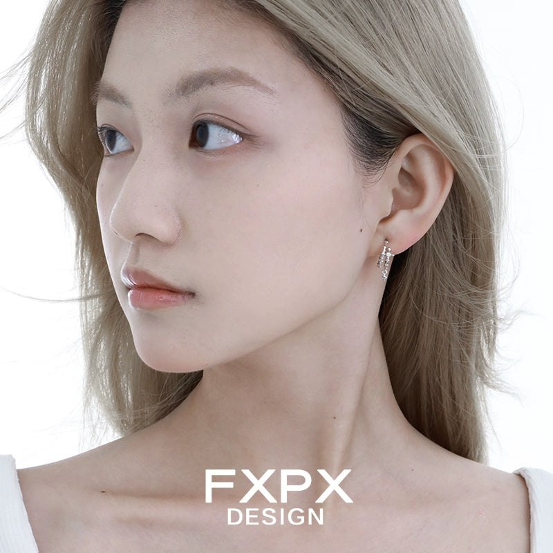 Elegant FXPX geometry silver earrings showcased on a model's ear for a stylish look