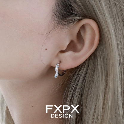 FXPX glacier blue snake earrings showcased on a model's ear for a stylish look
