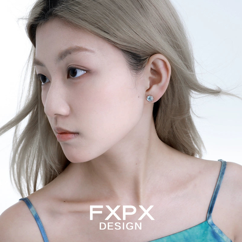 FXPX glacier drop earrings elegantly complementing a model's look with a soft hairstyle