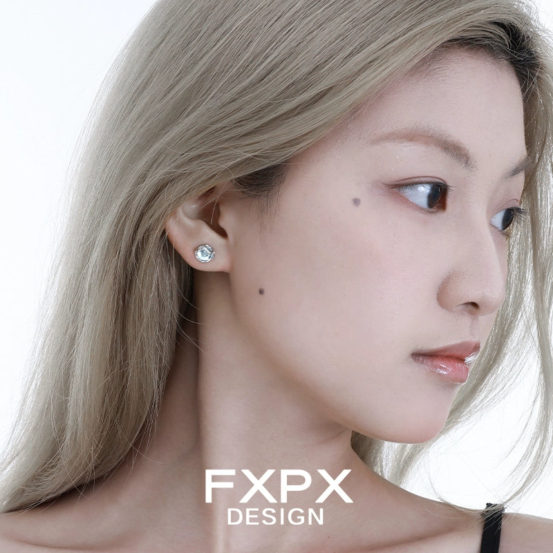 Elegant FXPX glacier drop earrings showcased on a model with long hair and a subtle profile