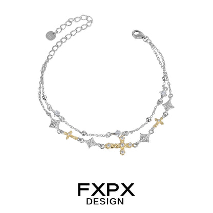 FXPX gold cross silver bracelet featuring intricate design and sparkling accents