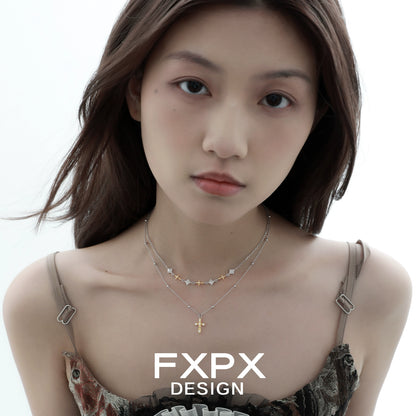 Stylish gold faith cross necklace layered with star charms, perfect for everyday wear