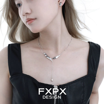 FXPX gothic angel wing earrings in silver design, stylishly worn with a black top for a bold look