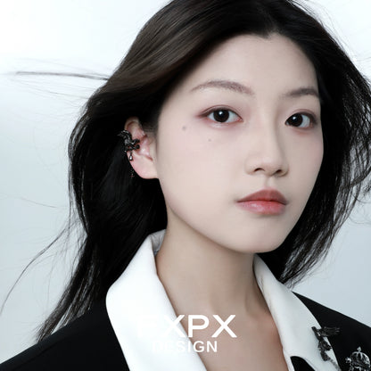 FXPX gothic crow ear cuffs displayed on a model with long dark hair and a stylish outfit