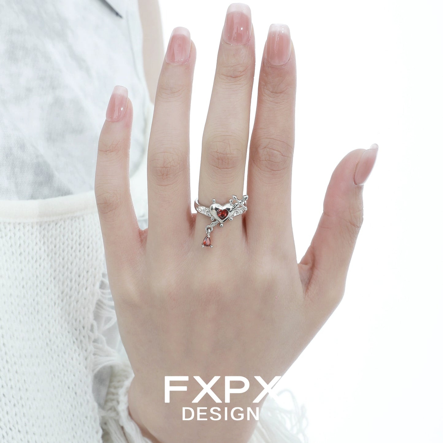 Silver gothic love promise ring with heart details worn on hand, perfect for romantic occasions