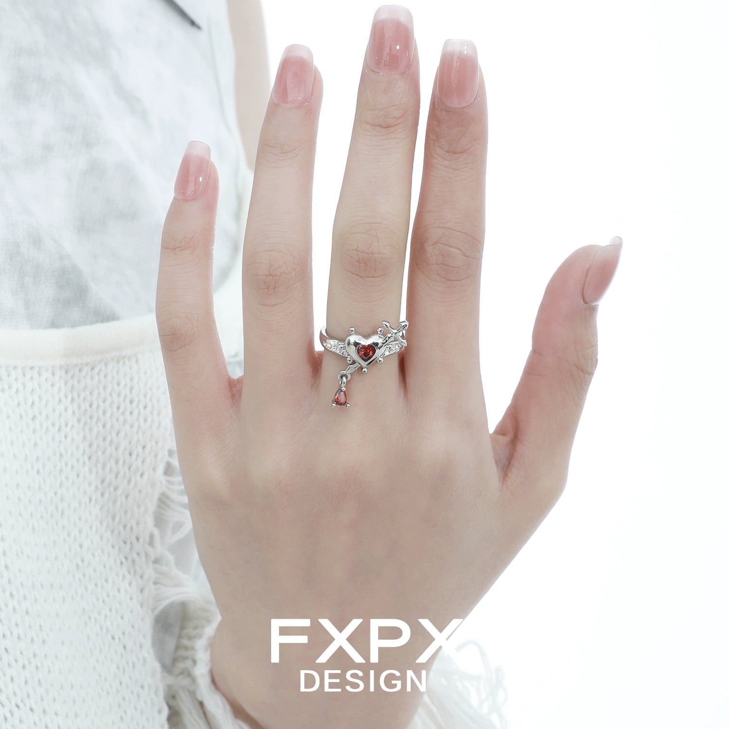 Silver gothic love promise ring with heart details worn on hand, perfect for romantic occasions