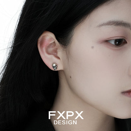 FXPX gothic skull silver earrings showcased on a model's ear for a stylish look