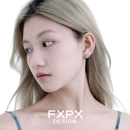 Stylish FXPX green snake earrings on a model showcasing a modern design