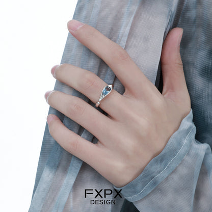 Elegant FXPX Iceland blue zircon ring displayed on a hand with stylish attire