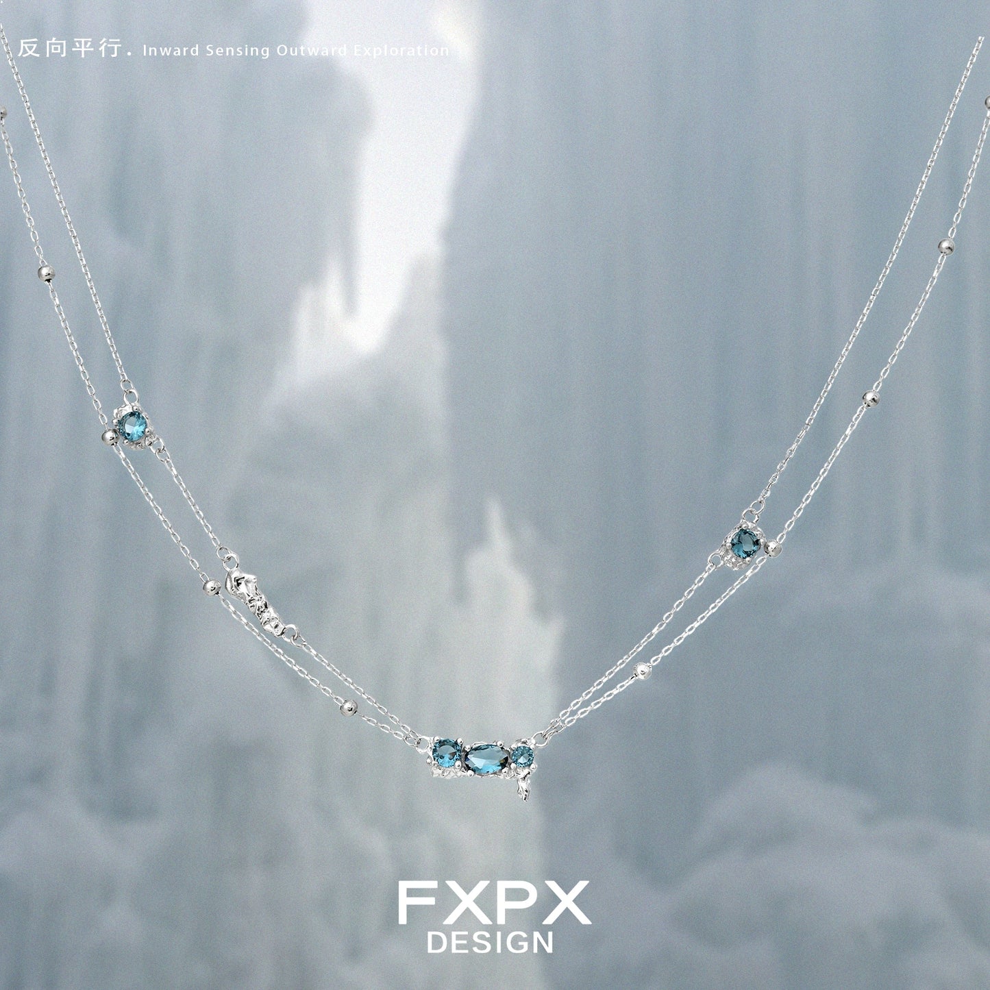 FXPX Icelandic blue zircon necklace with a delicate silver chain and sparkling blue gemstones