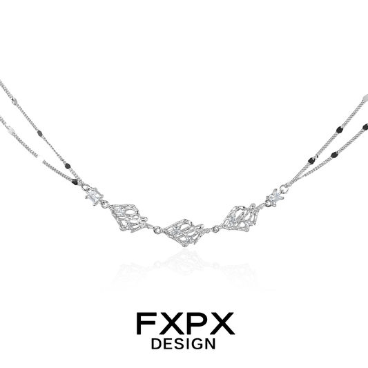 Layered silver gothic necklace featuring intricate design elements and multiple chain styles