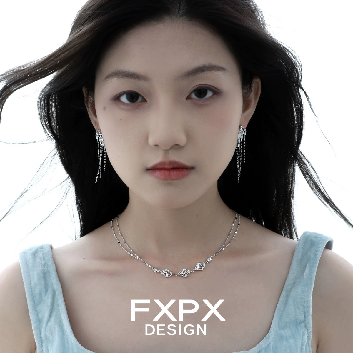 Layered silver gothic necklace by FXPX worn by a model with matching earrings