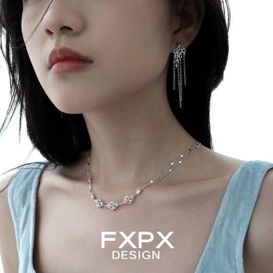 Layered silver gothic necklace showcased on a model with elegant styling
