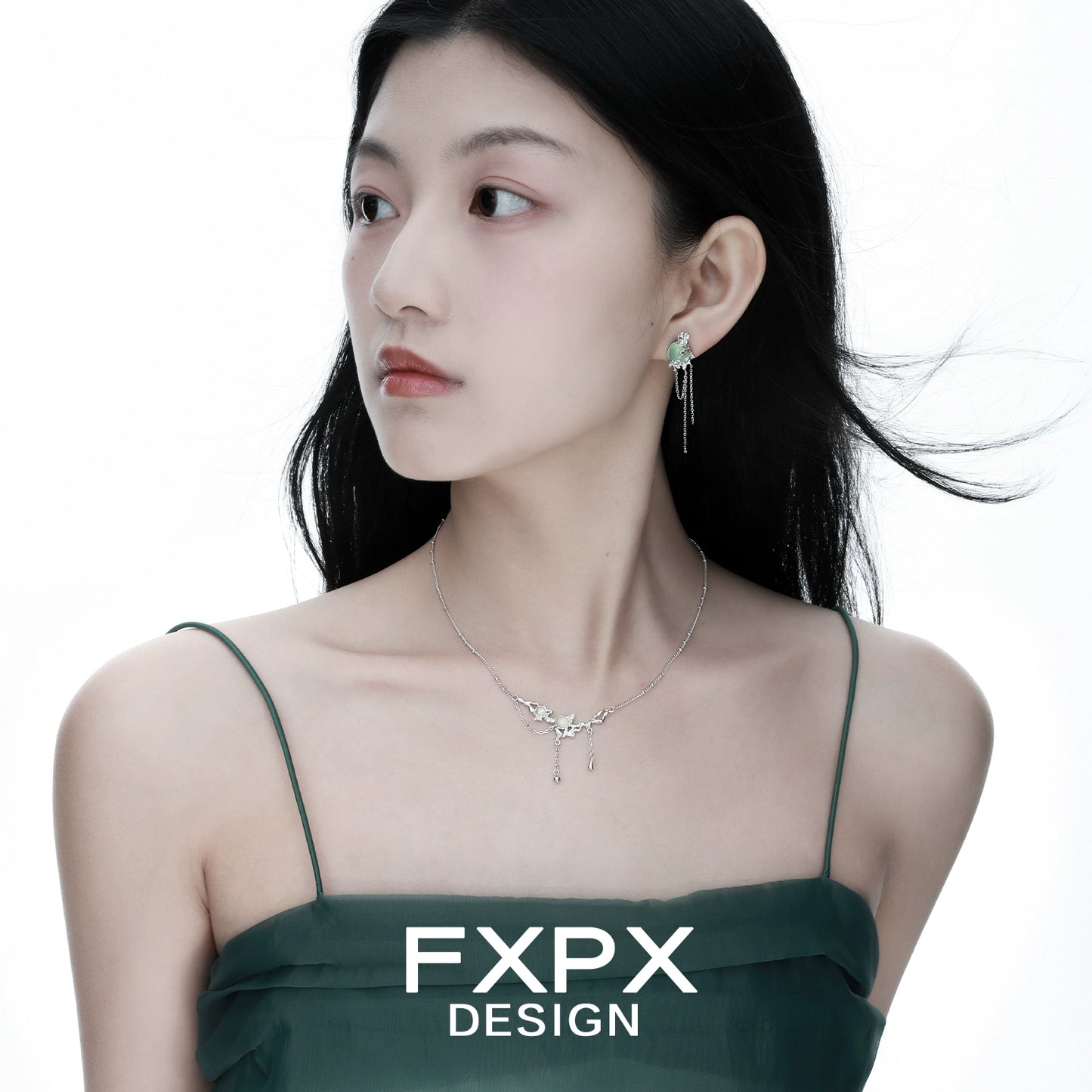 Elegant FXPX lotus pendant necklace displayed on a model with flowing hair and a stylish dress