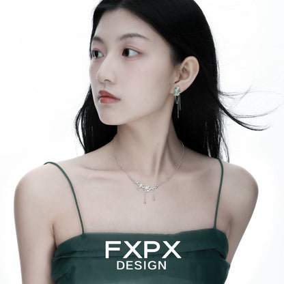 Elegant FXPX lotus pendant necklace displayed on a model with flowing hair and a stylish dress