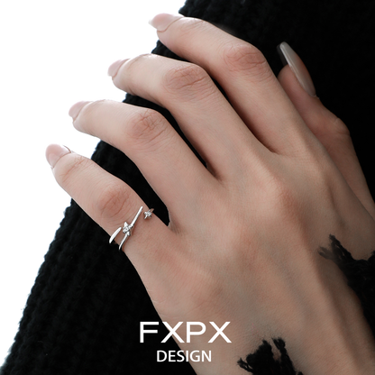 Delicate FXPX meteor track silver ring worn on a hand with elegant nail art