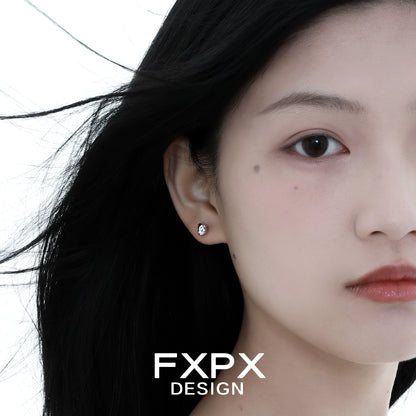 Stylish FXPX meteorite stud earrings showcasing a sleek and modern design on a model's ear