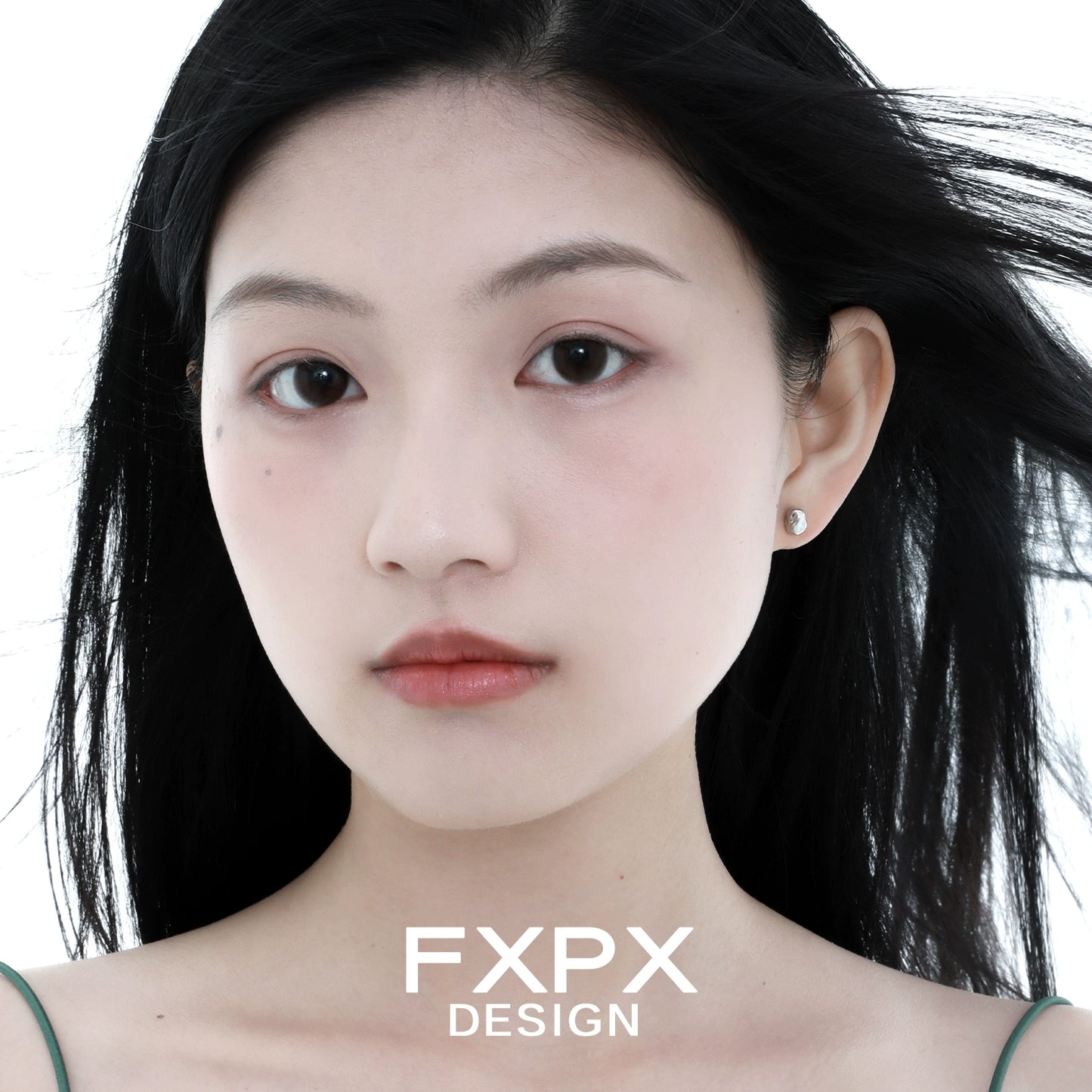 Elegant FXPX meteorite stud earrings showcased on a model with flowing hair