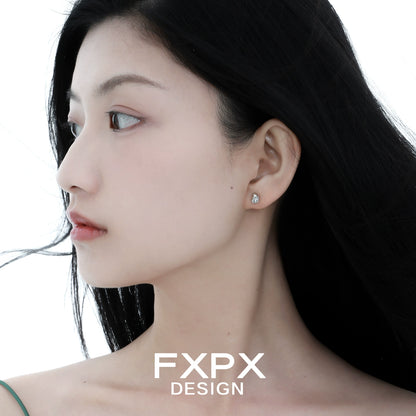 Elegant FXPX meteorite stud earrings showcased on a model for a chic and modern look