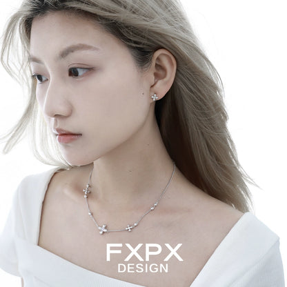 Elegant minimalist cross earrings from FXPX showcased on a model with wavy hair