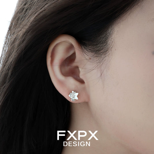 Minimalist star shell earrings designed by FXPX showcased on a model's ear