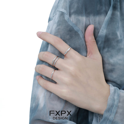 Stylish FXPX ocean breeze ring worn on a hand with multiple elegant rings